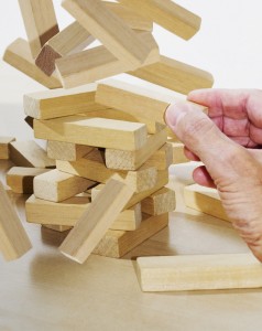 hand with falling building blocks